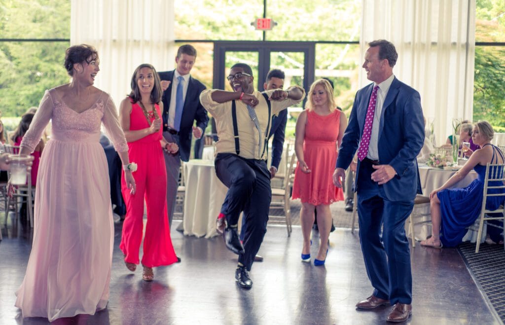 Photography by Atlanta wedding Photographer capturing guest dancing and having fun at the ceremony